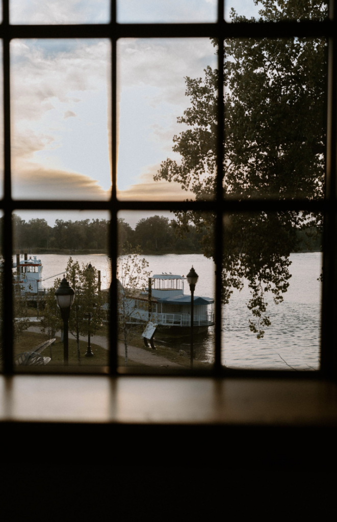 Glimpsing a boat on the river through the panes of a window.